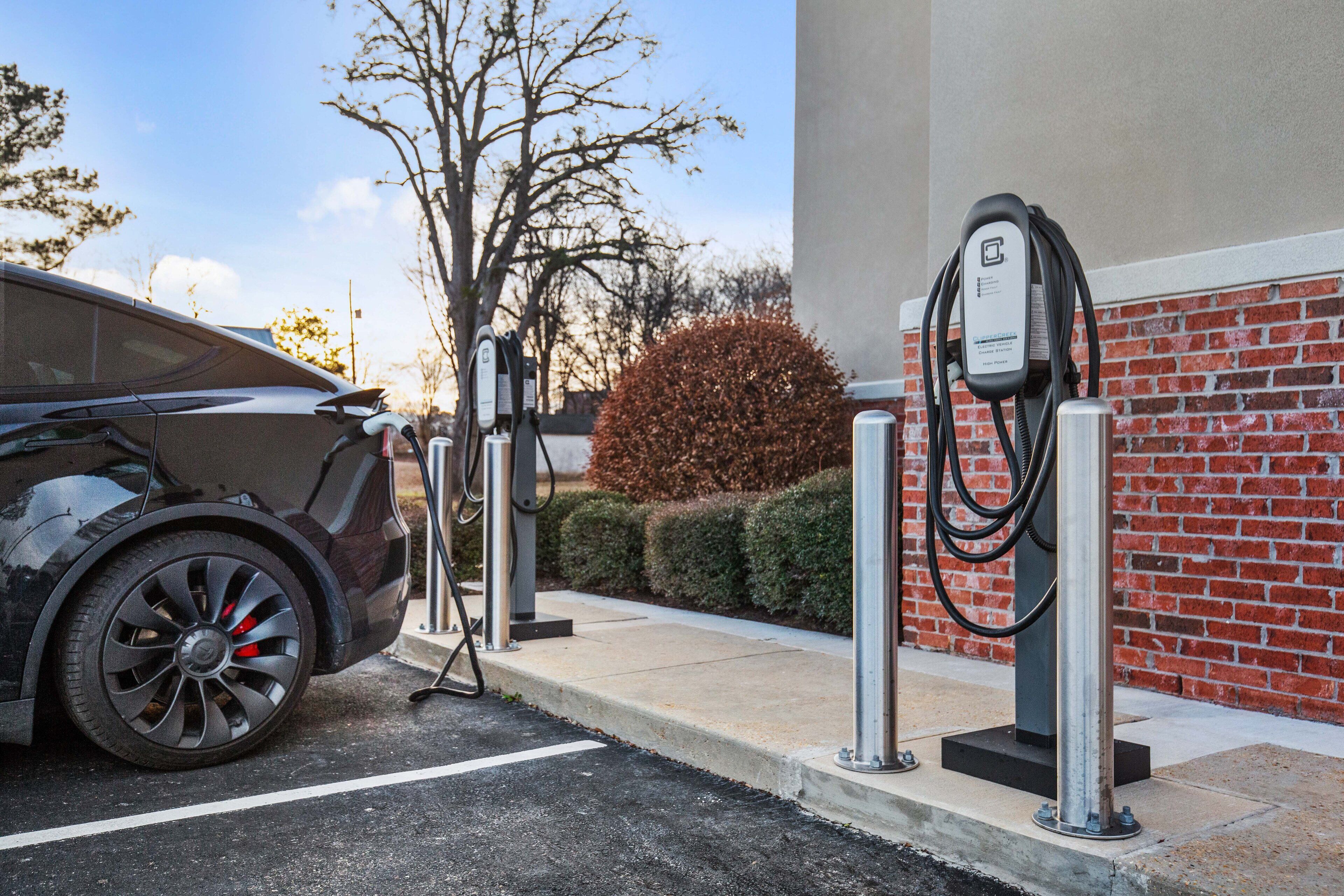 A car charging at a public electric vehicle charging station.