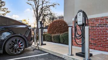 A car charging at a public electric vehicle charging station.