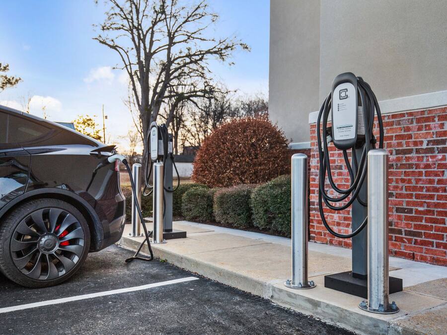 A car charging at a public electric vehicle charging station.