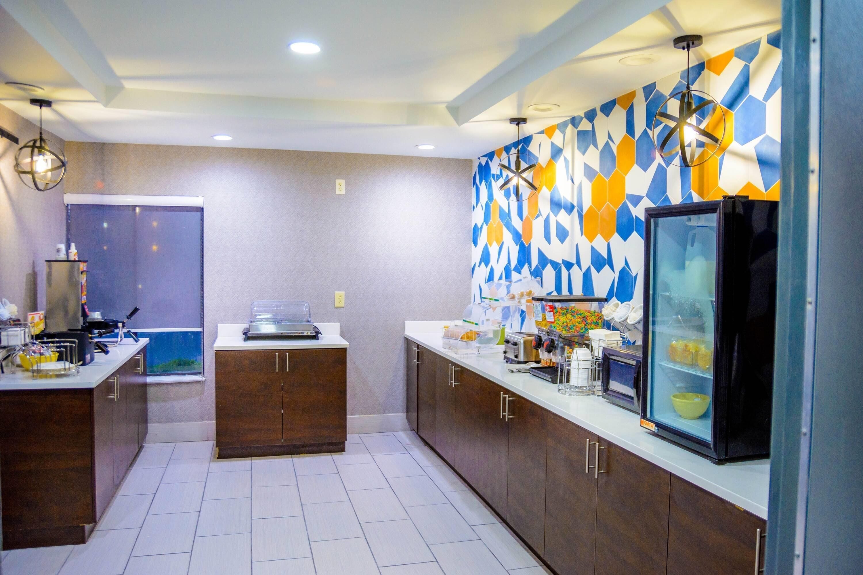 A modern kitchen with wooden cabinets, a refrigerator, and a microwave.