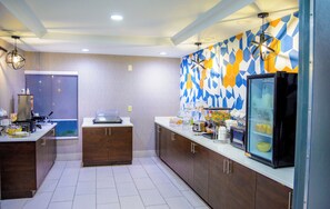 A modern kitchen with wooden cabinets, a built-in oven, and a refrigerator.