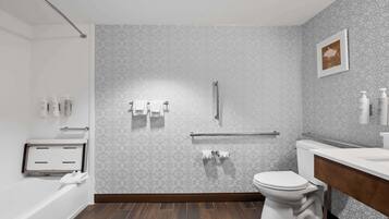 A modern bathroom with a patterned wall, a toilet, a sink, and a shower area.