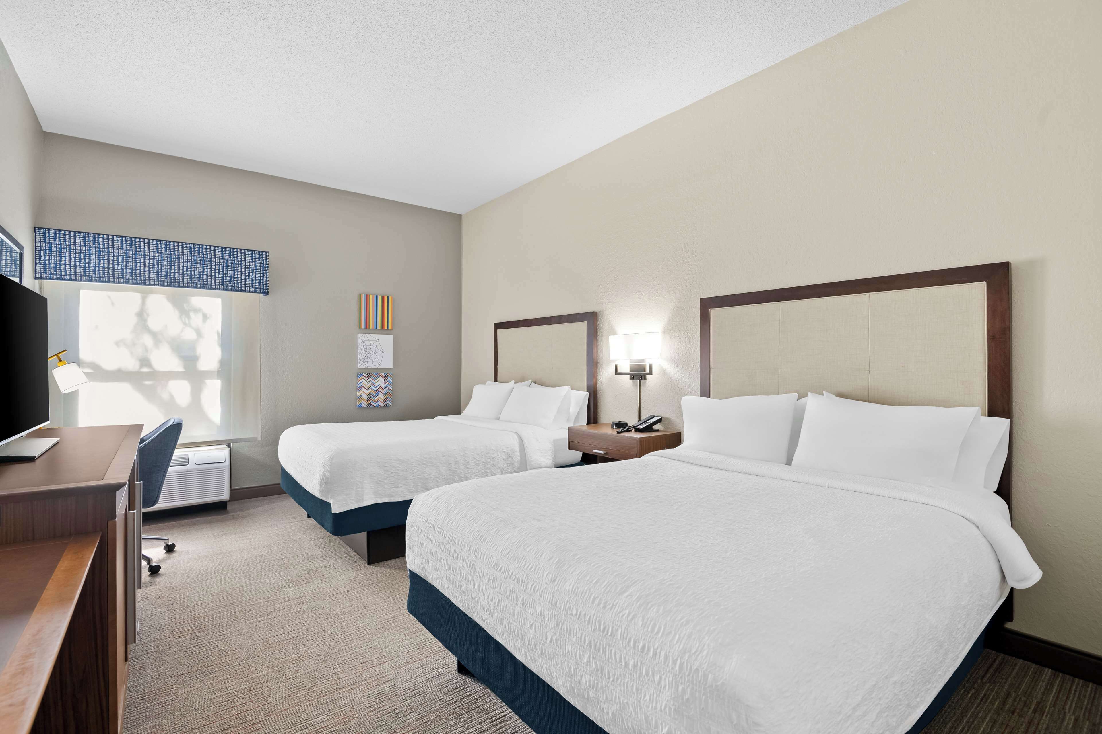 standard room with two queen beds | premium bedding, in-room safe, desk, laptop workspace