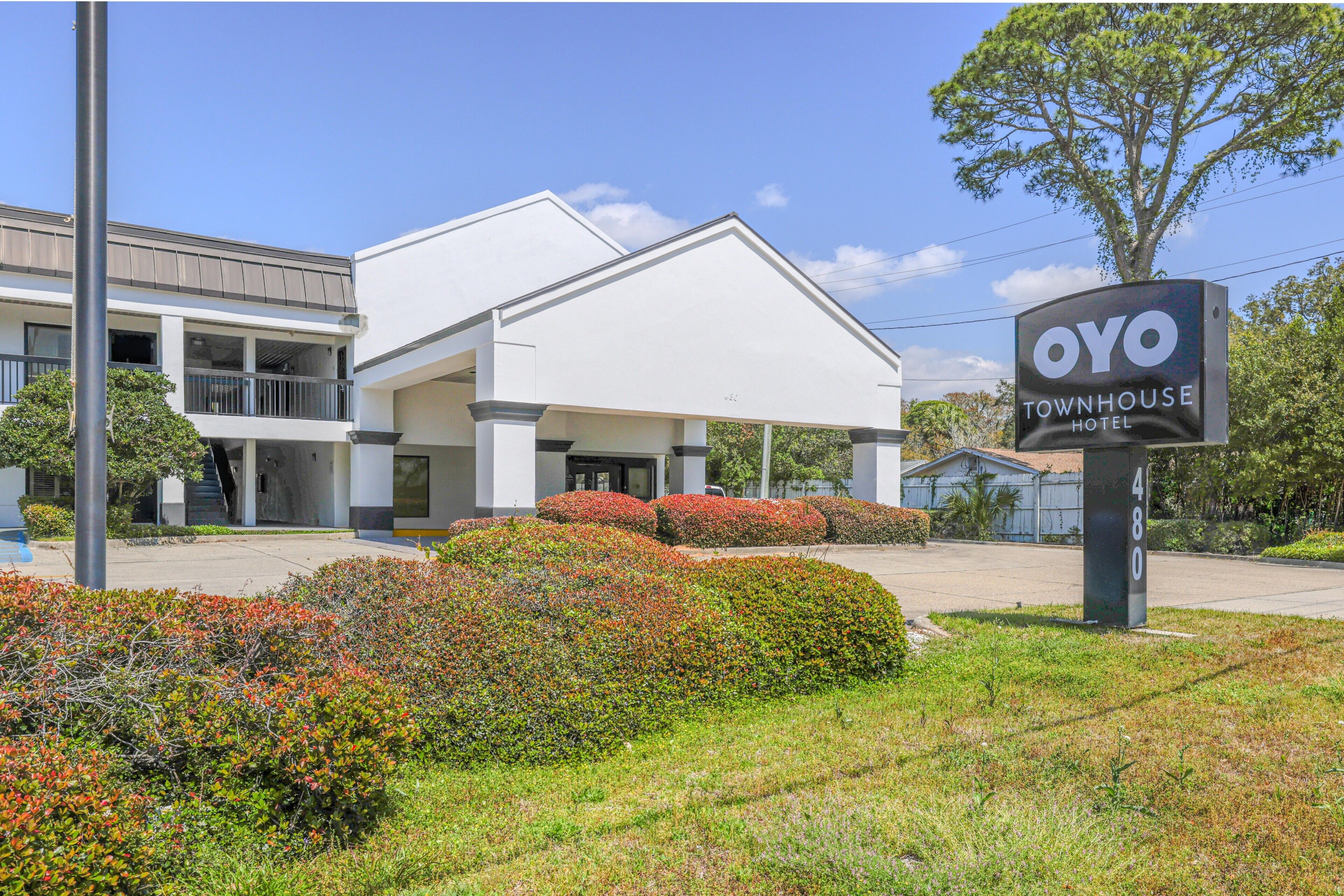 A modern building with a sign for OYO Townhouse Hotel.