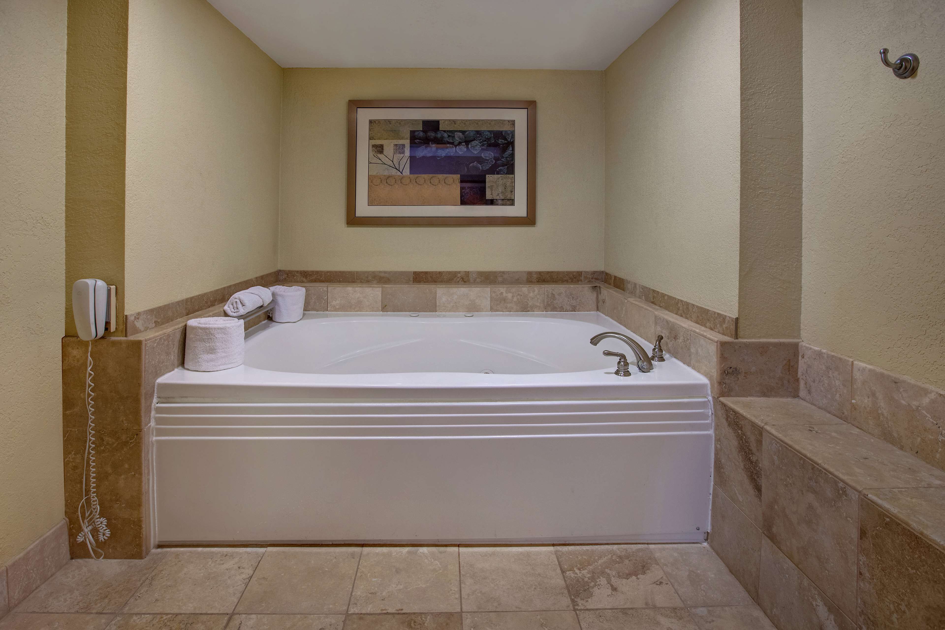 room, 1 king bed, refrigerator & microwave (jetted tub) | bathroom | free toiletries, hair dryer, towels