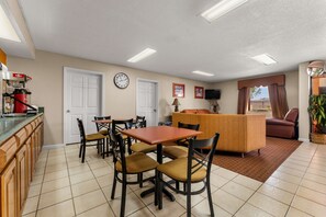 A compact living space with a kitchen, dining area, and a seating area.
