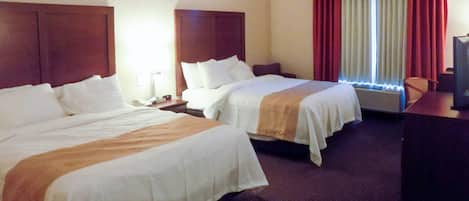 A hotel room with two beds, a desk, a chair, and a television.