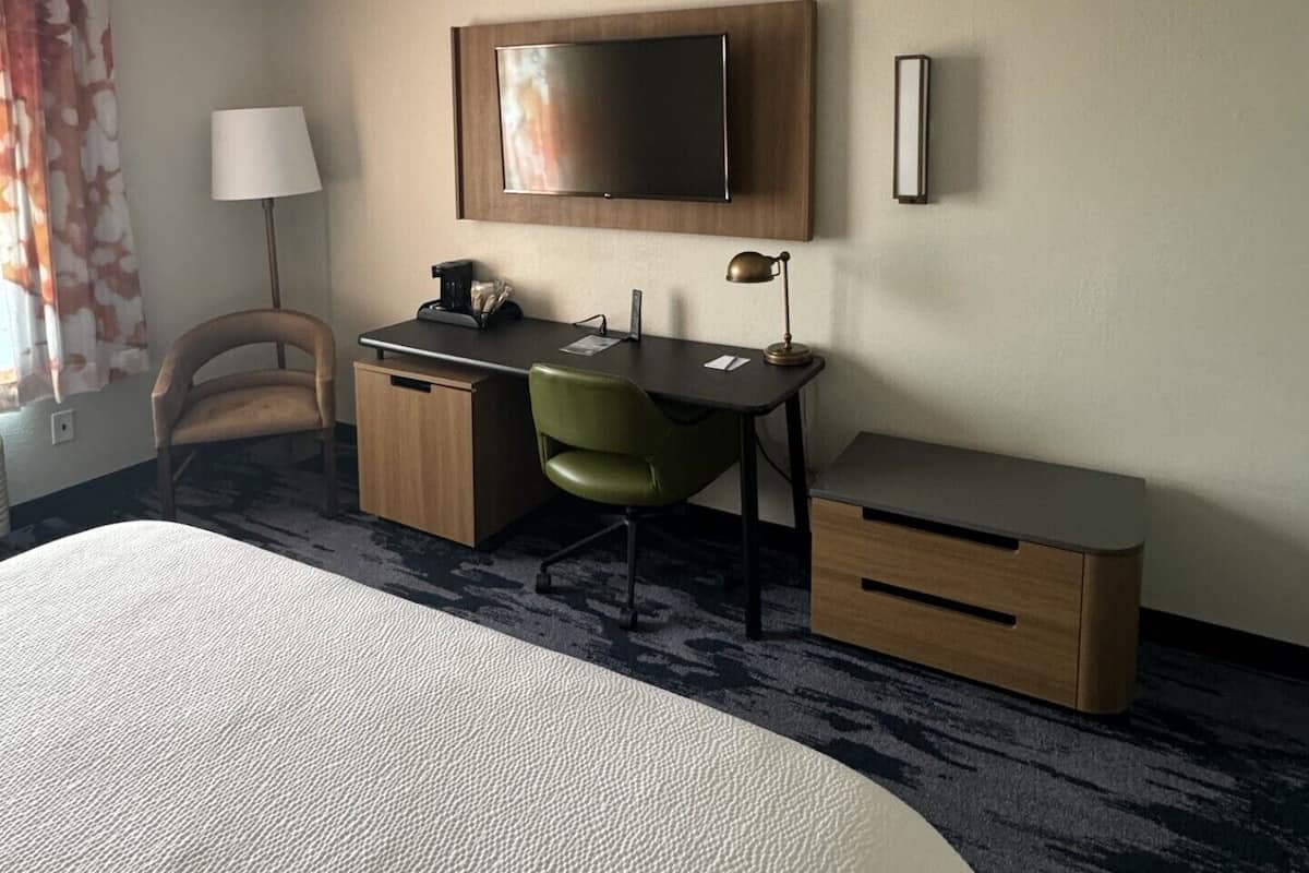 Premium bedding, desk, laptop workspace, blackout curtains