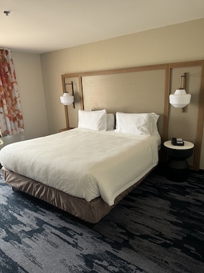 Premium bedding, desk, laptop workspace, blackout curtains