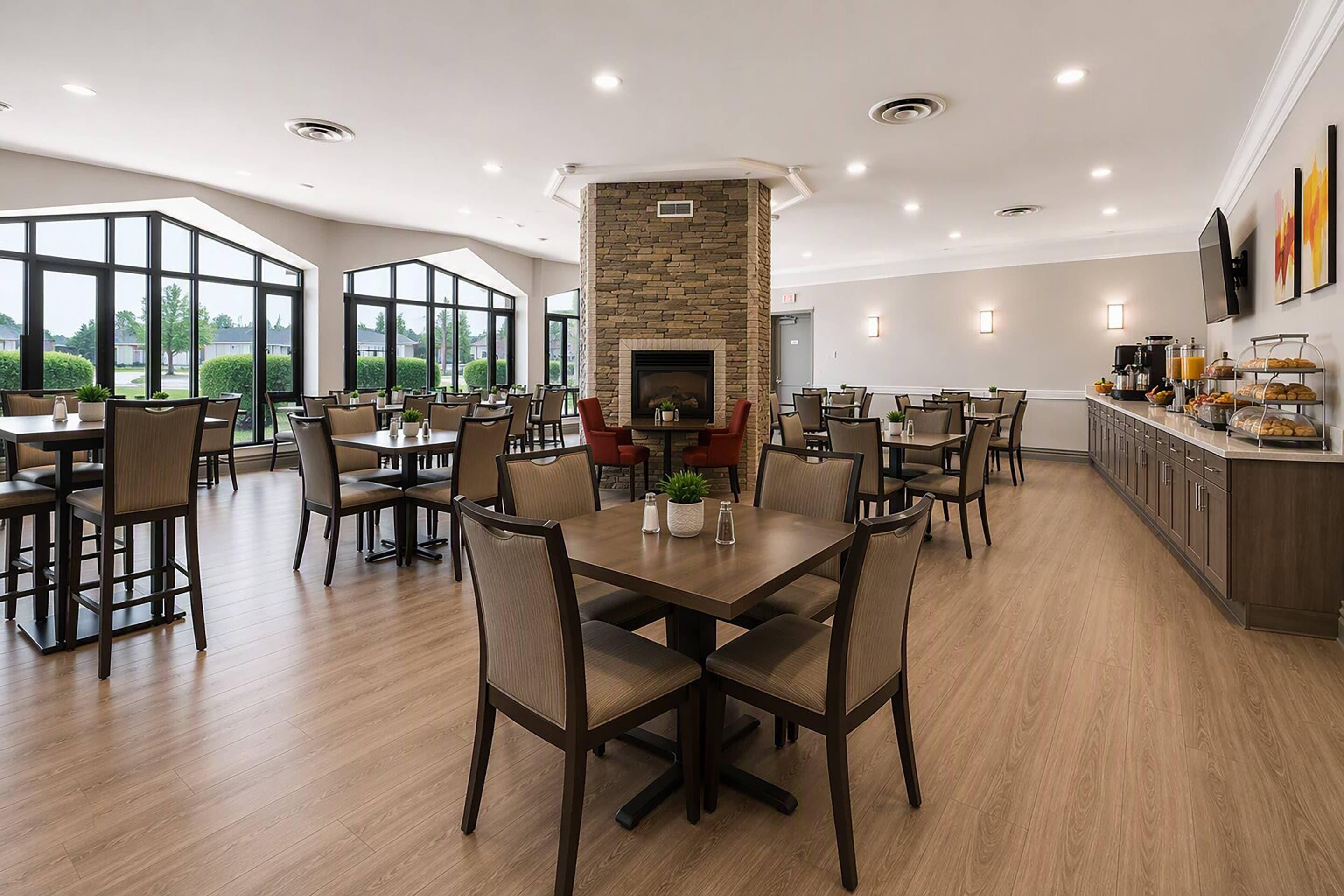 A spacious dining area with high ceilings, large windows, and a central stone fireplace.