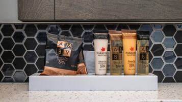 En uppvisning av AMBR Green Tea Spa-produkter, inklusive en påse med 30 g te, lotion, duschkräm, balsam och schampo.
