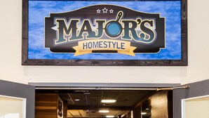 A restaurant interior with a sign reading "MAJOR'S HOMESTYLE" above the entrance. - Paradise Inn & Conference Centre (Grande Prairie)