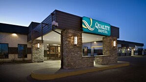 A hotel with a sign reading "Quality Hotel," featuring a modern design with stone pillars and a covered entrance. - Quality Hotel & Conference Centre Fort McMurray (Fort McMurray)