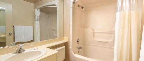 A bathroom with a sink, toilet, and bathtub.