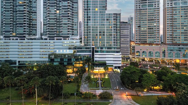 A high-rise hotel with multiple floors, a central courtyard, and a well-lit entrance. - InterContinental Miramar Panama by IHG (Panama City)
