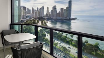 Un balcón con vistas a un horizonte urbano y una masa de agua.