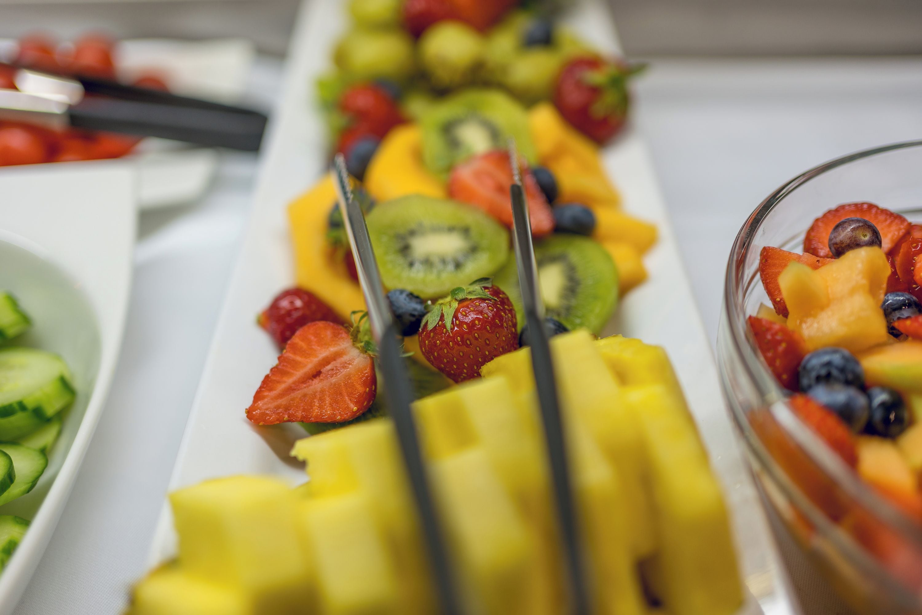 A buffet table with a variety of fruits and vegetables.