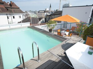 Seasonal outdoor pool, open 8:00 AM to 10:00 PM, pool umbrellas
