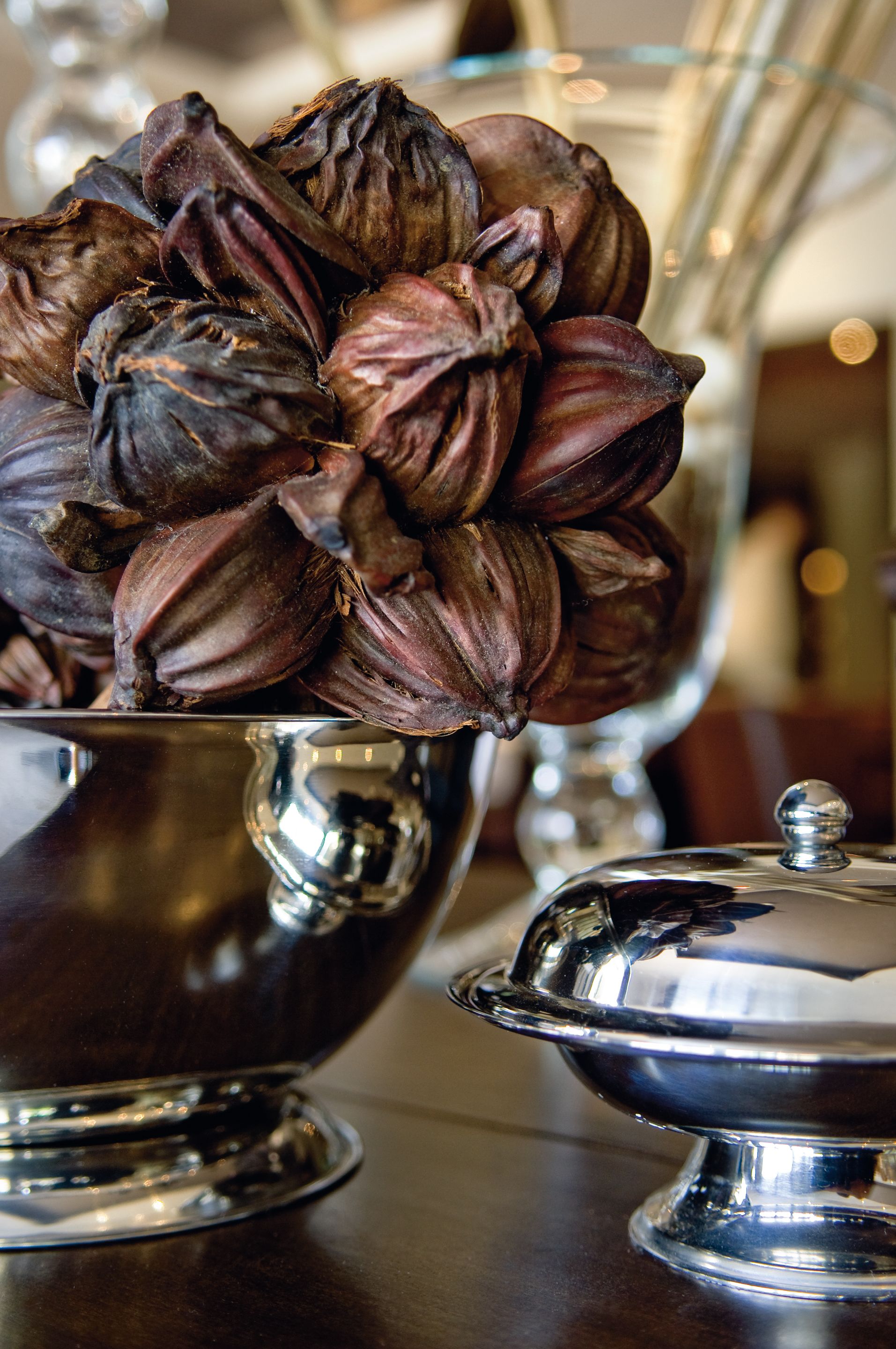 A silver serving dish filled with artichokes.