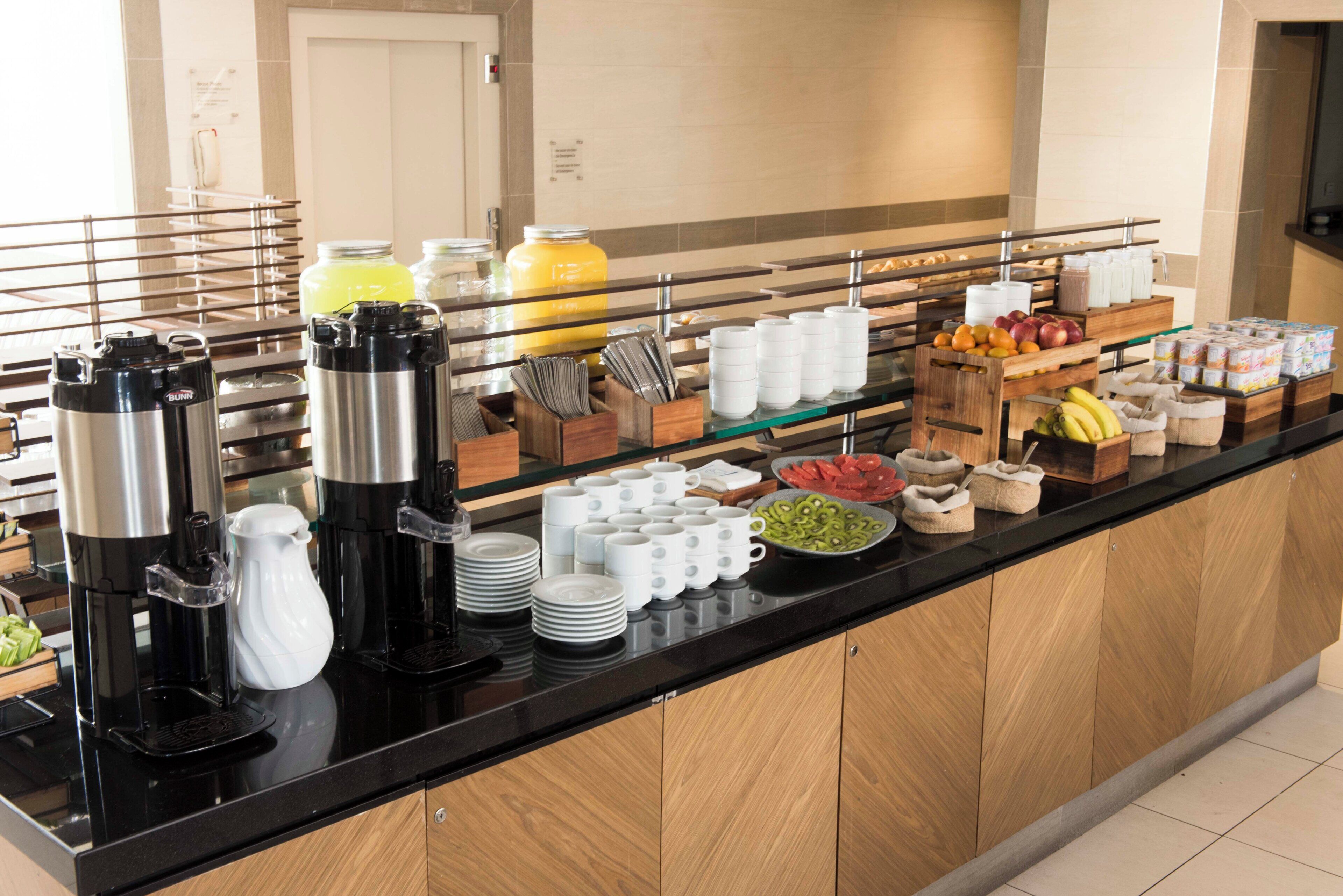 A buffet setup with various food items and beverages.