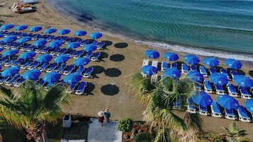 On the beach, sun loungers, beach umbrellas, beach towels