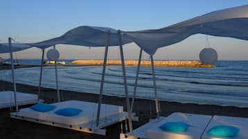 On the beach, sun-loungers, beach umbrellas, beach towels