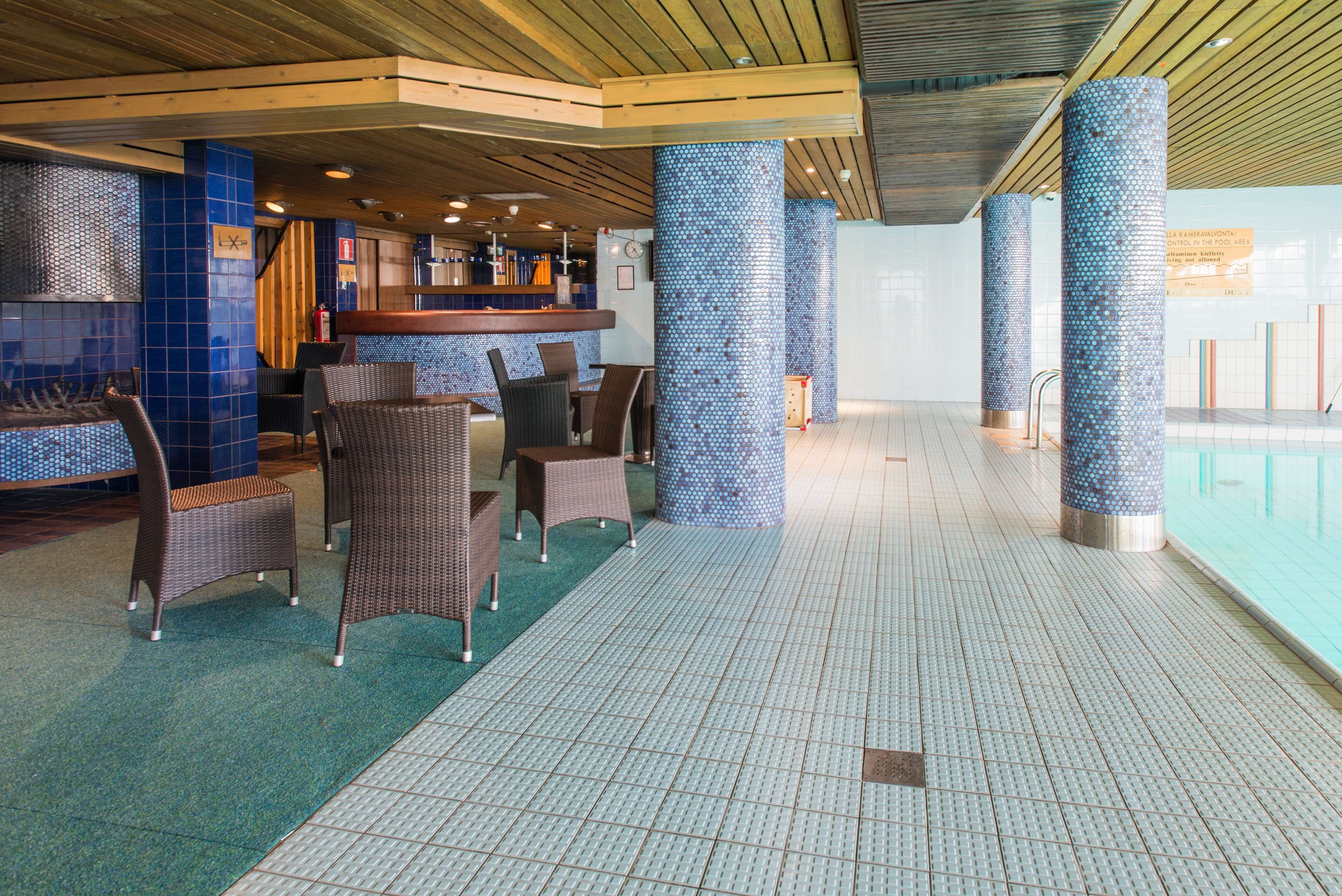 A pool area with seating and a bar.