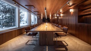 A conference room with a long table, chairs, and a large window overlooking a snowy landscape. - Scandic Pohjanhovi (Rovaniemi)