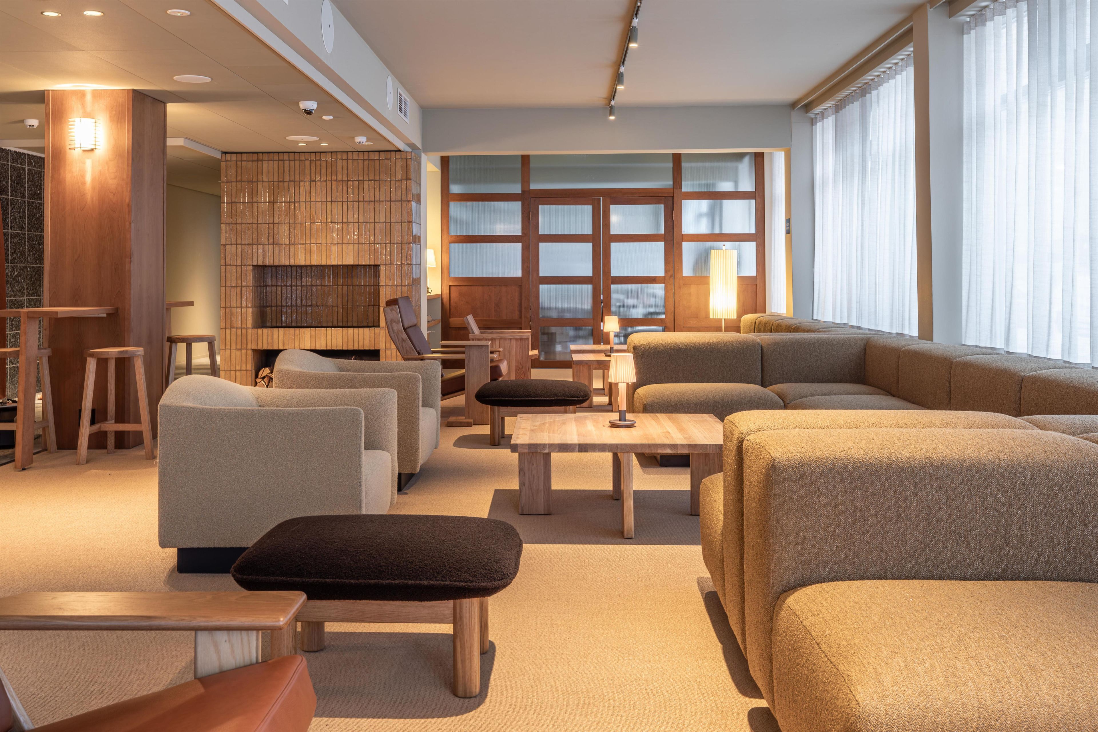 A modern living room with sofas, a coffee table, and a fireplace.