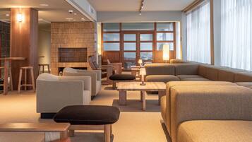A modern living room with sofas, a coffee table, and a fireplace.