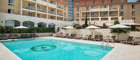 Seasonal outdoor pool, open 9:00 AM to 8:00 PM, pool umbrellas