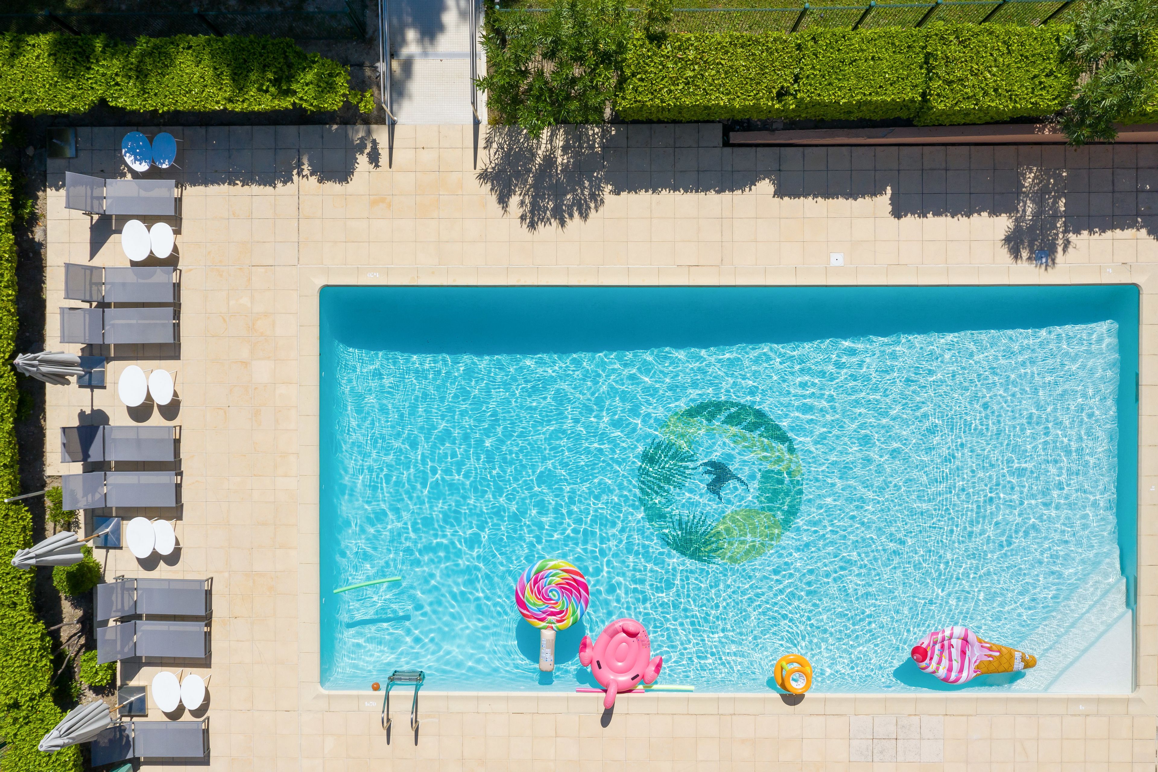 Seasonal outdoor pool, open 9:00 AM to 8:00 PM, pool umbrellas