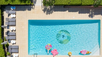 Seasonal outdoor pool, open 9:00 AM to 8:00 PM, pool umbrellas