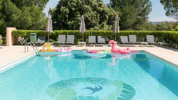 Seasonal outdoor pool, open 9:00 AM to 8:00 PM, pool umbrellas
