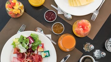 Un bufé de desayuno con diversas opciones de alimentos y bebidas.