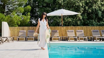 Seasonal outdoor pool, open 9:00 AM to 8:00 PM, pool umbrellas