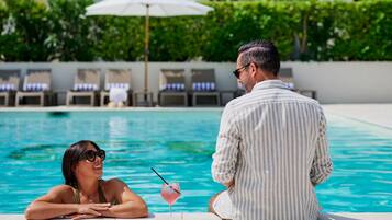 Seasonal outdoor pool, open 9:00 AM to 8:00 PM, pool umbrellas