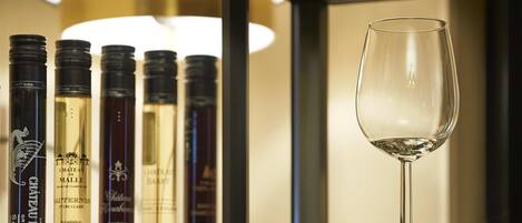 A wine rack with bottles and a wine glass.