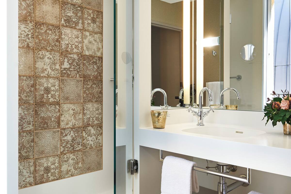 rainfall showerhead, designer toiletries, hair dryer, towels