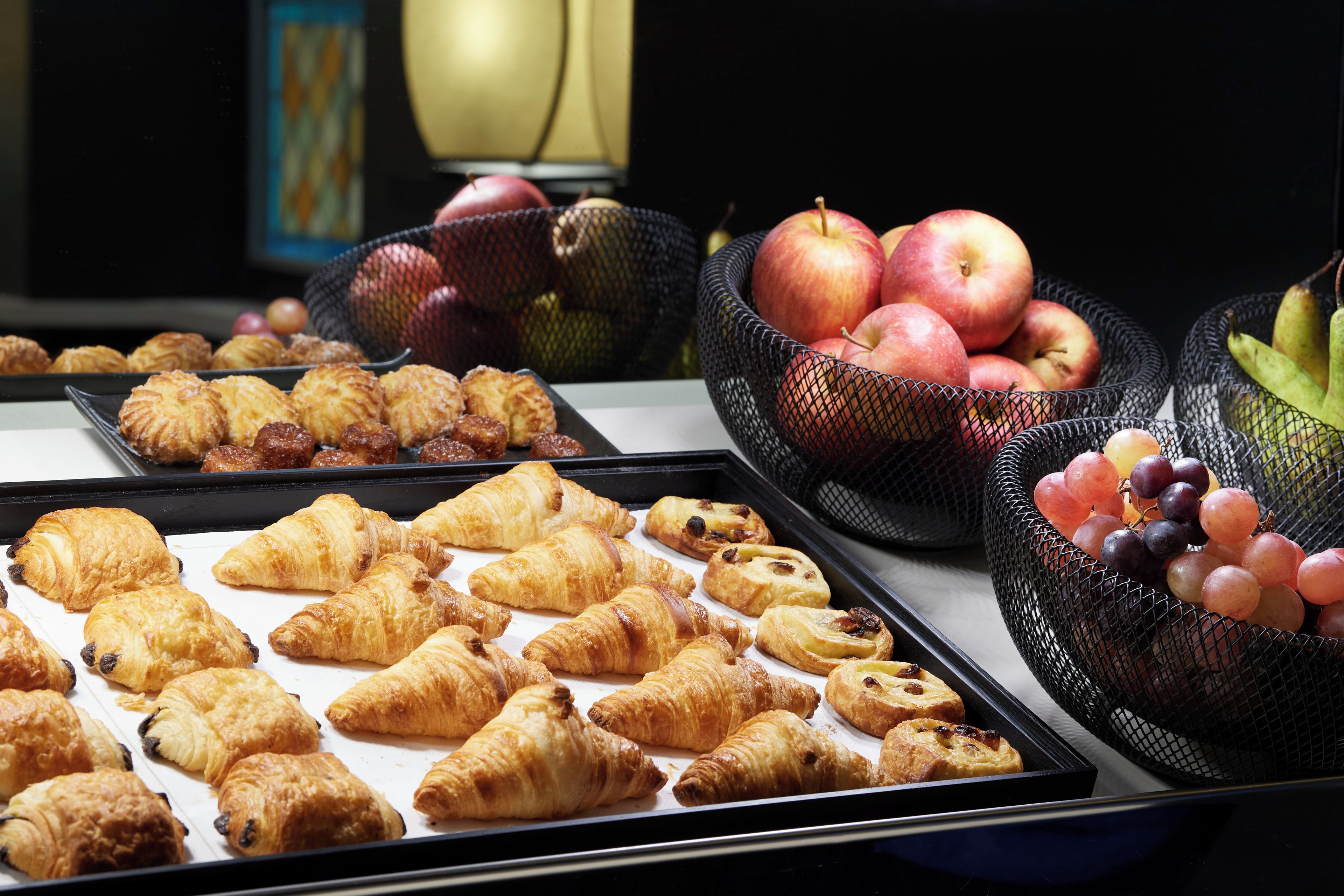 A display of pastries and fruits.