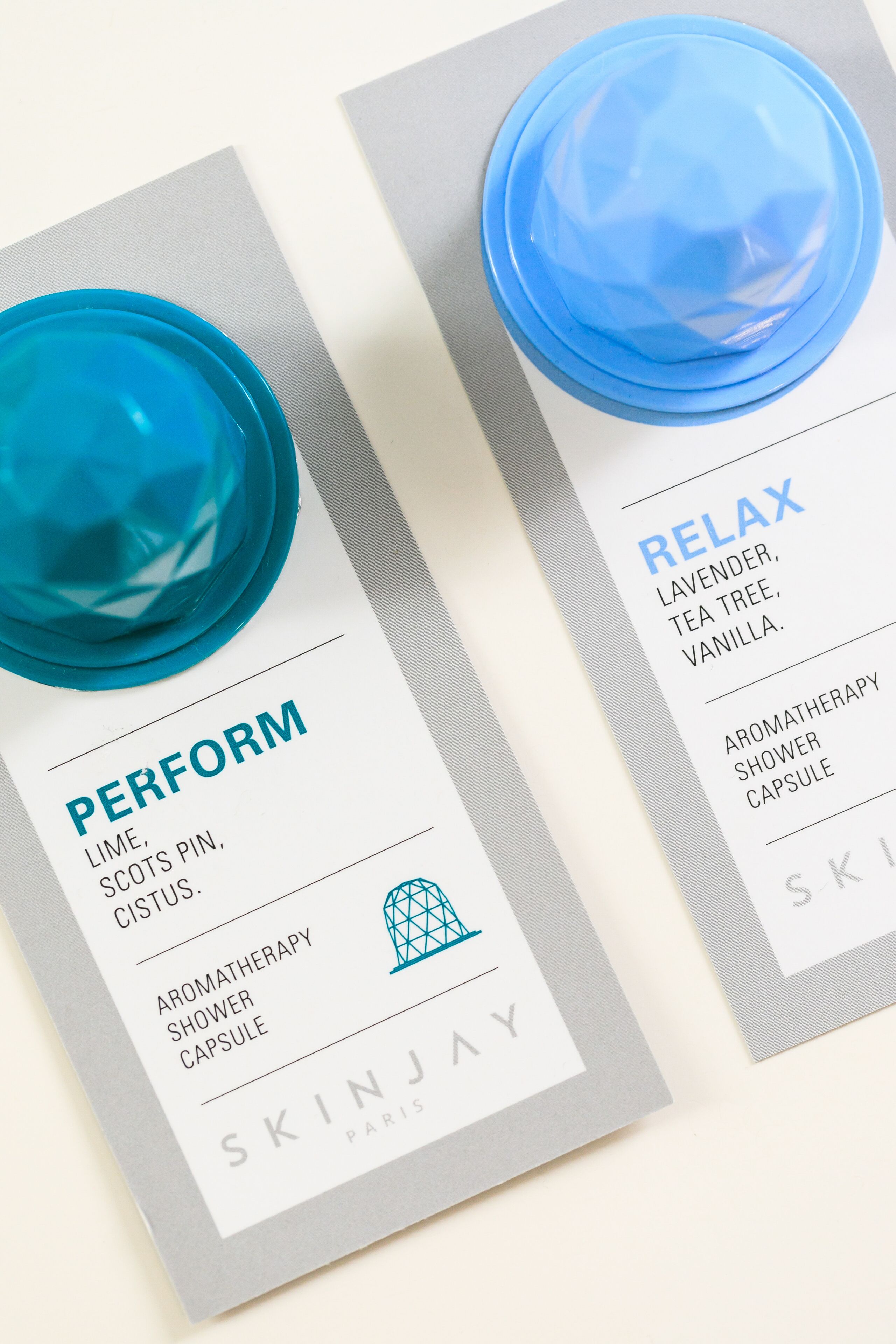 Two skincare product boxes with labels indicating 'PERFORM' and 'RELAX' scents, and the brand 'SKINJAY PARIS'.