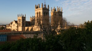 A historic building with multiple towers and arched windows, surrounded by trees. - Best Western Hotel Le Guilhem (Montpellier)