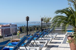 Seasonal outdoor pool, open 10:00 AM to 5:00 PM, pool umbrellas