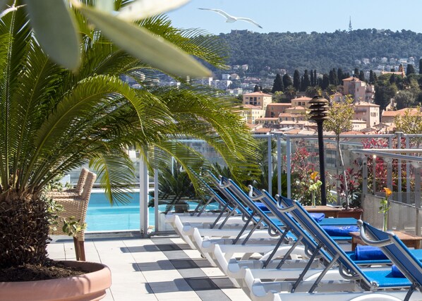 Seasonal outdoor pool, open 10:00 AM to 5:00 PM, pool umbrellas