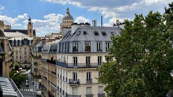 A row of historic buildings with balconies, a prominent tower, and a dome.