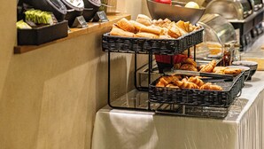 A buffet setup with various food items and a coffee station. - Hotel Claude Bernard Saint Germain (Paris)