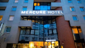 The exterior of the Mercure Hotel with a modern architectural design, featuring large windows and a prominent entrance. - Mercure Paris Montparnasse Pasteur (Paris)