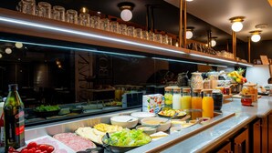 A buffet with various food items, beverages, and condiments. - Mercure Paris Montparnasse Pasteur (Paris)
