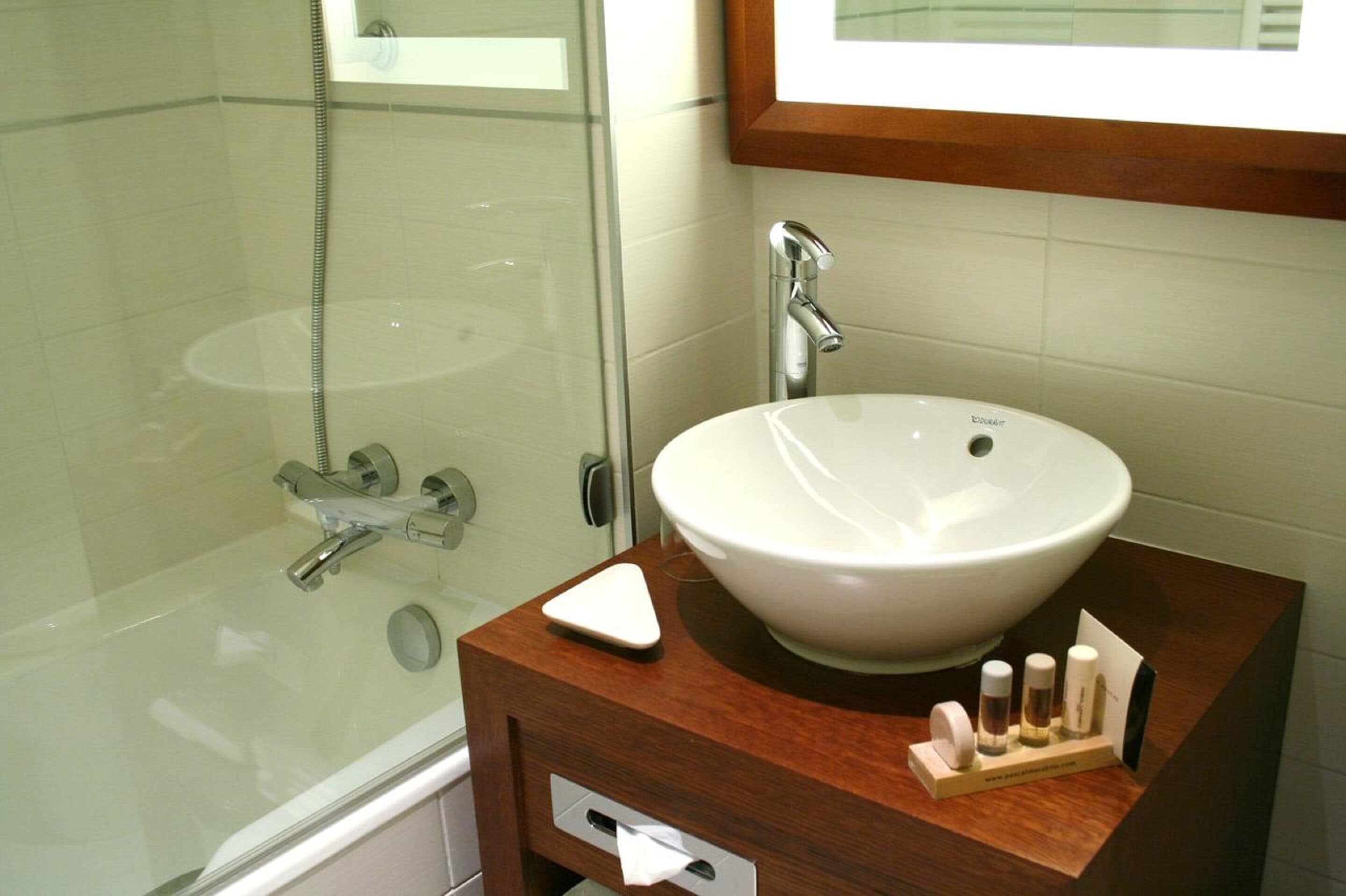 designer toiletries, hair dryer, slippers, towels