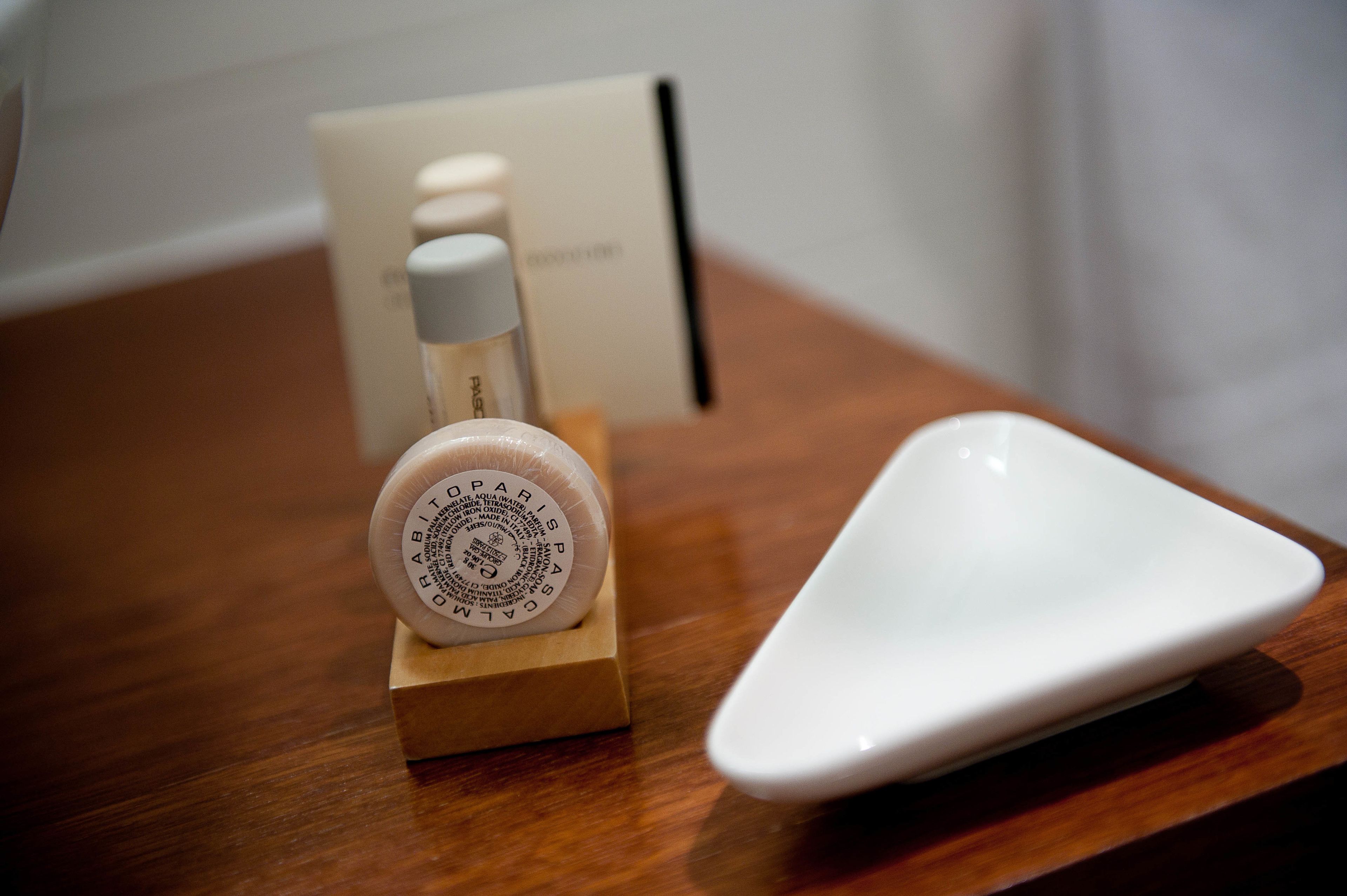 designer toiletries, hair dryer, slippers, towels